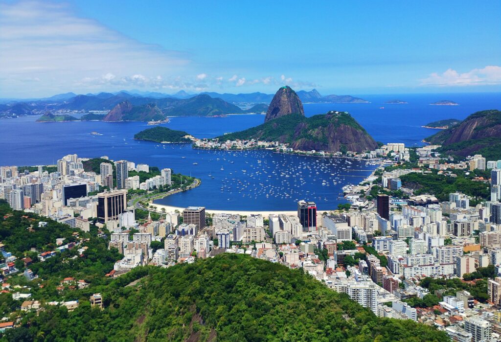 A breathtaking aerial view of Rio de Janeiro's coast showcasing Sugarloaf Mountain and vibrant cityscape.